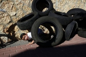 Boy under a pile of tires